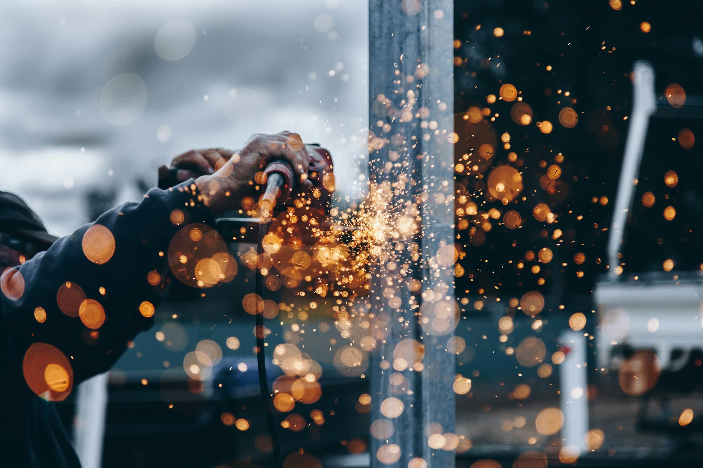 Welding closeup, sparks against dark steel